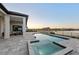 Inviting pool and spa with a covered patio, dining set, and a beautiful sunset at 1702 4Th St E E St, Palmetto, FL 34221
