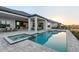 Inviting pool and spa with a covered patio, dining set, and a beautiful sunset at 1702 4Th St E E St, Palmetto, FL 34221