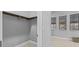 A walk-in closet has a wooden rail and shelf, with carpet and gray walls at 1702 4Th St E E St, Palmetto, FL 34221