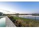 Tranquil view from the backyard overlooking the water, lush greenery, and a boat dock at 1702 4Th St E E St, Palmetto, FL 34221