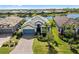 Aerial view of home with paver driveway and well-maintained landscaping with water view at 17228 Corinna Pl, Bradenton, FL 34202
