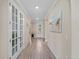 Hallway features wood-look floors, neutral paint, and glass-paned doors at 17228 Corinna Pl, Bradenton, FL 34202