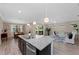 Open-concept kitchen with a view of the dining room, living room, and screened patio at 17228 Corinna Pl, Bradenton, FL 34202