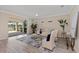 Bright and airy living room offering views of the lanai and backyard through sliding glass doors at 17228 Corinna Pl, Bradenton, FL 34202