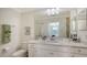 Charming bathroom with walk-in shower, white vanity, quartz countertops, and decorative accents at 17510 Gawthrop Dr # 305, Bradenton, FL 34211