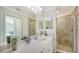 Beautiful bathroom featuring a tiled walk-in shower and a white vanity with quartz countertop at 17510 Gawthrop Dr # 305, Bradenton, FL 34211