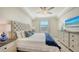 Comfortable bedroom with plush carpeting, decorative pillows, side tables, dresser and large window at 17510 Gawthrop Dr # 305, Bradenton, FL 34211