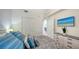 Bright bedroom featuring a bed with decorative pillows, double closets, and a mounted television at 17510 Gawthrop Dr # 305, Bradenton, FL 34211