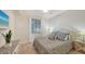 Charming bedroom with blue and gold accents, a large window, and a dresser with decorative plant at 17510 Gawthrop Dr # 305, Bradenton, FL 34211