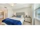 Comfortable bedroom with plush carpeting, decorative pillows, side tables and a large window with a view at 17510 Gawthrop Dr # 305, Bradenton, FL 34211