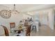 Bright dining area with glass table and pendant lighting, adjacent to the modern kitchen at 17510 Gawthrop Dr # 305, Bradenton, FL 34211
