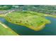 Aerial view of a lush golf course that sits among beautiful residential houses and lakes at 17510 Gawthrop Dr # 305, Bradenton, FL 34211