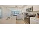 Bright kitchen featuring stainless appliances, stone counter, and open layout into the living spaces at 17510 Gawthrop Dr # 305, Bradenton, FL 34211