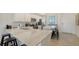 Stylish kitchen with white cabinets, quartz countertops, stainless steel appliances, and breakfast bar seating at 17510 Gawthrop Dr # 305, Bradenton, FL 34211