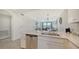Bright, modern kitchen with stainless steel appliances and quartz countertops blends seamlessly into living area at 17510 Gawthrop Dr # 305, Bradenton, FL 34211