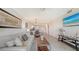 Open-concept living room featuring tile floors, neutral decor, and access to kitchen and dining area at 17510 Gawthrop Dr # 305, Bradenton, FL 34211