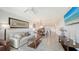 Open-concept living room with modern decor, connecting kitchen, and TV at 17510 Gawthrop Dr # 305, Bradenton, FL 34211