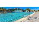 Beautiful pool view with waterfall features and ladder, offering an inviting space for relaxation and recreation at 17510 Gawthrop Dr # 305, Bradenton, FL 34211