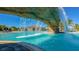 Stunning pool featuring rock waterfall features, lush palms, and clear blue waters for a resort-like atmosphere at 17510 Gawthrop Dr # 305, Bradenton, FL 34211