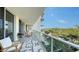 Wide open balcony with chairs and views of the water and foliage at 1800 Benjamin Franklin Dr # B308, Sarasota, FL 34236
