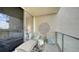 Comfortable balcony loungers with a view looking into the condo's interior at 1800 Benjamin Franklin Dr # B308, Sarasota, FL 34236
