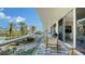 Wide condo balcony featuring seating with a view of the surrounding landscape and nearby high-rise at 1800 Benjamin Franklin Dr # B308, Sarasota, FL 34236
