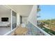 Condo balcony featuring seating, garden views, and access to the living area at 1800 Benjamin Franklin Dr # B308, Sarasota, FL 34236