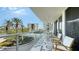 Spacious condo balcony overlooking mature greenery, with comfortable seating and scenic views at 1800 Benjamin Franklin Dr # B308, Sarasota, FL 34236
