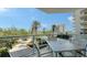 Relaxing balcony setting with cozy seating, lovely landscaping, and community views at 1800 Benjamin Franklin Dr # B308, Sarasota, FL 34236
