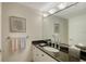 Bathroom vanity with granite countertop, decorative mirror, and modern fixtures at 1800 Benjamin Franklin Dr # B308, Sarasota, FL 34236