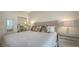 Bedroom features a comfortable bed, neutral colors, and mirrored closet at 1800 Benjamin Franklin Dr # B308, Sarasota, FL 34236