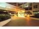 Entrance of the building with palm trees and manicured landscaping at night at 1800 Benjamin Franklin Dr # B308, Sarasota, FL 34236