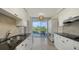 Bright, modern kitchen with black counters, white cabinets, and picturesque balcony views at 1800 Benjamin Franklin Dr # B308, Sarasota, FL 34236