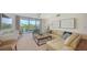 Inviting living room with modern furniture, neutral colors, and balcony access with lush outdoor views at 1800 Benjamin Franklin Dr # B308, Sarasota, FL 34236