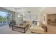Bright living room leading to balcony, boasting neutral colors, comfortable seating, and serene views at 1800 Benjamin Franklin Dr # B308, Sarasota, FL 34236