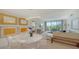 Open-concept living and dining area with modern lighting, balcony access, and stylish decor at 1800 Benjamin Franklin Dr # B308, Sarasota, FL 34236