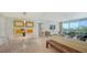 Living and dining area featuring modern furnishings, neutral tones, balcony access, and modern decor at 1800 Benjamin Franklin Dr # B308, Sarasota, FL 34236
