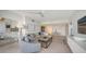Bright living room with modern furnishings, comfortable seating, and open layout to dining area at 1800 Benjamin Franklin Dr # B308, Sarasota, FL 34236