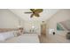 Bedroom featuring balcony access, a ceiling fan, and coastal decor and furniture at 1800 Benjamin Franklin Dr # B308, Sarasota, FL 34236