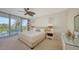Bright bedroom features a ceiling fan, balcony access, and coastal decor at 1800 Benjamin Franklin Dr # B308, Sarasota, FL 34236