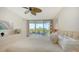 Spacious bedroom featuring balcony access, a ceiling fan, and coastal decor at 1800 Benjamin Franklin Dr # B308, Sarasota, FL 34236