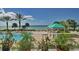 Resort pool with gulf views, palm trees, and lounging area at 1800 Benjamin Franklin Dr # B308, Sarasota, FL 34236