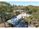 Aerial view of a home featuring solar panels, lush landscaping and mature shade trees at 2213 Wason Rd, Sarasota, FL 34231