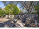 Fenced backyard with established trees features a charming fire pit area with seating at 2213 Wason Rd, Sarasota, FL 34231