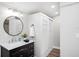 Bathroom features a stylish vanity with black cabinets and a convenient wardrobe closet at 2213 Wason Rd, Sarasota, FL 34231
