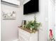 Charming bedroom decor includes a dresser, TV, decorative plant, and artwork, creating a cozy atmosphere at 2213 Wason Rd, Sarasota, FL 34231