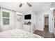 This bedroom has a TV, ceiling fan, and dresser with a decorative plant adding a fresh touch at 2213 Wason Rd, Sarasota, FL 34231