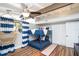 Bedroom featuring a bunk bed, hammock chair, and nautical-themed striped curtains at 2213 Wason Rd, Sarasota, FL 34231