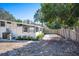 The home's exterior features a wood fence, fresh landscaping, and a well-manicured yard at 2213 Wason Rd, Sarasota, FL 34231