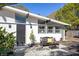 Stylish home entrance with black front door, modern lighting, and cozy seating area at 2213 Wason Rd, Sarasota, FL 34231